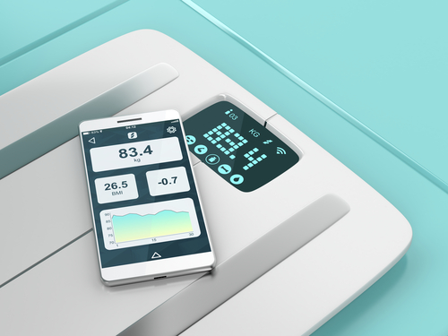 smart scale with phone sitting on top of it